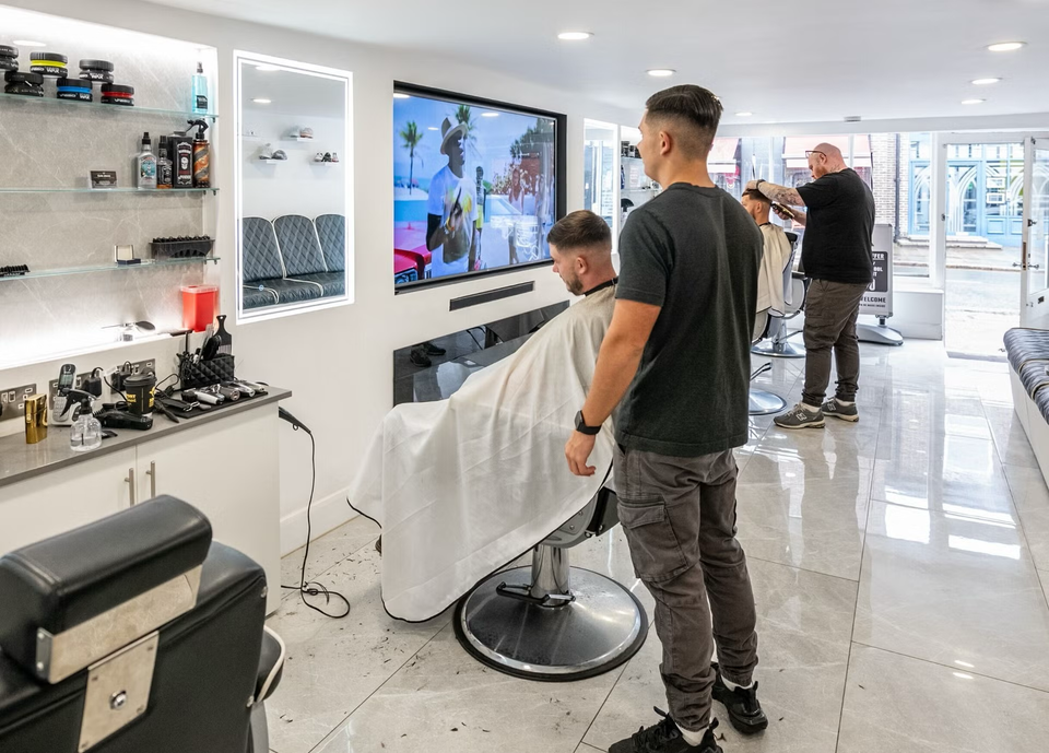 The Grays team cutting hair in our bright Ewell barbershop